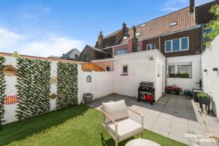 This recently and quality renovated house enjoys a quiet yet extremely central location within walking distance of the historic center of Bruges. Thanks to thoughtful renovations, the home is ready for a new chapter.<br /><br />Technically, the property features a certified electrical installation and holds a valid EPC certificate with an energy label B (198 kWh/m²).<br /><br />The layout of the house is as follows:<br /><br />On the ground floor, you will find a spacious and bright entrance hall that leads to the cozy living area with an open kitchen. The fully equipped kitchen offers all modern comforts, including a combination oven, dishwasher, induction cooktop, extractor hood, one-and-a-half sink, and a fridge with freezer compartment. Additionally, the ground floor includes a large storage/laundry room and a separate guest toilet.<br /><br />On the first floor, there is a night hall, two spacious bedrooms, and a well-maintained bathroom fitted with a bathtub with shower option, a sink with vanity, and a second toilet.<br /><br />A fixed staircase leads to the particularly spacious attic floor, which is ideal as an office, hobby room, or versatile extra space.<br /><br />At the back of the house, you will find a large terrace accessible via the central heating storage room, where you can enjoy the outdoors in complete peace and quiet.<br /><br />Highlights of this property:<br />• Energy-efficient character – EPC label B (198 kWh/m²)<br />• Certified electrical installation<br />• Move-in ready<br />• Quality renovations with high-end finishing<br />• Two spacious bedrooms<br />• Large attic with multiple possibilities<br />• Spacious terrace<br />• Quiet yet very central location near the center of Bruges<br />• Compliance certificate available<br /><br />More information or to schedule a visit? Contact our office.