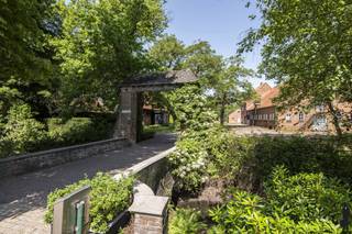 <strong>Uniek gelegen eigendom 'domein 'Klein Hoef'', gekend als de oudste hoeve van Retie, nabij centrum en uitstekend commercieel doch natuurlijk-groen gelegen aan de Retiese ring richting Kasterlee/Oud-Turnhout en nabij de Nederlandse grens. Het onroerend goed, gelegen op een perceel van maar liefst 11.465m² bestaat uit (i) een ruime zaak (ca. 500m²) waarin thans klassebrasserie 'De Klynhoeve' is gevestigd (handelshuur eindigt 2028), (ii) een woning met riant stalgebouw voor opslag (totaal ca. 340m²), en (iii) enkele bijgebouwen (oude stal achteraan, overdekte opslag vooraan). </strong><br /><br /><strong>Het geheel biedt een unieke kans voor ondernemers/investeerders die dromen van een bloeiende horecazaak met riante woongelegenheden. Het eigendom biedt tal van mogelijkheden gelet op de verschillende gebouwen en de private ligging; bovendien omgeven door uitgestrekte natuurbossen (onder meer richting Groendomein Prinsenpark) en verschillende fiets- en wandelroutes. Er is een energielabel D voor woonhuis met stal (geen renovatieverplichting) en een label G voor de brasserie. </strong><br /><br /><span>Dit uitzonderlijke vastgoedgeheel dient gerenoveerd te worden (o.a. elektriciteit, renovatie woning, aanleg tuin). </span><br /><br /><span>Aangrenzend zijn er legio parkeermogelijkheden en liggen enkele hectaren grond die tevens aangekocht kunnen worden: info op aanvraag.<br /><br /></span><strong></strong><span>Algemeen</span><strong>:<br /></strong>Aan de Kleine Nete gelegen omwalde hoevesite met een eeuwenoude oorsprong; de oudste bronnen vermelden het hoevecomplex reeds begin 16e en midden 17e eeuw. De hoeve met bijgebouwen zoals deze thans doorgaat bestaat sinds begin 20ste eeuw uit losstaande bestanddelen, rondom een erf geschikt: een woonstalhuis (nok loodrecht op de straat), een parallel gelegen schuur met bijschuurtje waarin thans Brasserie 'Klynhoeve' wordt uitgebaat, een toegangspoort.<br /><br />De hoevesite met oud grachtensysteem werd in de 20ste eeuw verder uitgewerkt en geïntegreerd in het nieuwe kasteeldomein; de hoeve diende een bloeiend landbouwbedrijf te worden dat het kasteel en ook de dorpelingen voorzag van groenten, fruit, melk en vlees. Zo kreeg de 'Klein Hoef' een gestructureerde aanleg met een moestuin, een omgrachte kleine en grote boomgaard, en een essenbos. De eiken van de Grote Dreef en andere aanplantingen langs de grachten vormden een natuurlijk scherm tussen park en hoevesite.<br /><br /><span>Horecazaak (brasseriegebouw)</span>:<br />Van de huidige hoevegebouwen zijn de monumentale schuur en toegangspoort de oudst bewaarde. Het huidige hoofdschuurvolume is ca. 1992 sterk verbouwd en gerenoveerd tot café-brasserie. Dit gebouw bestaat uit een verbruikzaal, keuken, opslag en wintertuin; er is verder ook een terras aanwezig. Een suggestie van het de binnenkant/het interieur van de brasserie kunt u bekijken via de website van de brasserie (https://deklynhoeve.be/).<br /><br />Het handelsfonds is niet mee over te nemen - handelshuur eindigt in 2028: informatie op aanvraag.<br /><br /><span>Woongedeelte en stallingen</span>:<br />Van het oorspronkelijk woonstalhuis werd in 1952 de stal en in 1963 ook het woonhuis vervangen door de huidige. Deze delen van het onroerend goed verdienen een totaalrenovatie. Voor de bouw van het woonhuis zijn evenwel degelijke materialen gebruikt: arduinen dorpels, dak in rode pannen, houten ramen en kornissen.<br /><br />De woning beschikt over een ruime zitplaats en leefruimte. Er zijn 4 slaapkamers voorzien en een riante zolder. De woning is tevens onderkelderd (kleine provisiekelder - niet droog). De aan de woning aansluitende stalling beschikt over ca. 215m² extra aan stal-/opslagruimte; en biedt zo legio feitelijke mogelijkheden naar invulling toe. Er is gasaansluiting aanwezig.