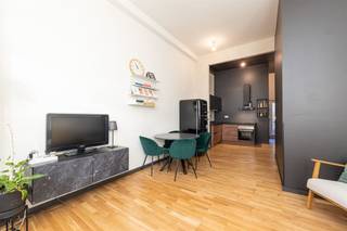 <p><span> </span></p><p><span>Op zoek naar een instapklare stek op een supercentrale locatie? Dit recent gerenoveerde één-slaapkamerappartement op het gelijkvloers combineert een modern interieur, hoog plafond, veel licht, een gezellig terrasje én een praktische indeling. In een kleinschalig gebouw zonder maandelijkse kosten én met kelderberging en fietsenstalling </span></p><p><span> </span></p><p><span>Strak &amp; warm wonen</span></p><p><span>In de leefruimte geniet je meteen van de hoge plafonds en het vele licht dat binnenvalt via de grote ramen. De houten vloer en de zachte tinten creëren een warme, moderne sfeer. Een perfecte leefhoek met ruimte voor een eetplek én cozy zithoek.  De open keuken vormt een mooi geheel met de leefruimte. Ze is volledig uitgerust met oven, kookplaat, dampkap, vaatwasser en spoelbak — ideaal voor wie graag kookt. De donkere tinten, houtaccenten en strakke lijnen geven de keuken een stijlvolle uitstraling. Vanuit de keuken stap je via de achterdeur naar het terras.</span></p><p><span> </span></p><p><span>Badkamer &amp; wasplaats</span></p><p><span>De badkamer is compact maar slim ingericht en voorzien van een moderne douche, lavabo en toilet. De tegelvloer maakt het praktisch en onderhoudsvriendelijk.  Handig detail: de aparte wasplaats met aansluiting voor wasmachine bevindt zich vlak ernaast.</span></p><p><span> </span></p><p><span>Rustige slaapkamer &amp; Gezellig terrasje</span></p><p><span>Achteraan ligt de ruime slaapkamer, weg van de straatkant, met voldoende plaats voor een dubbel bed en kleerkasten. Dankzij de ligging aan de koer geniet je hier van extra rust.  De private buitenruimte is perfect voor een koffiemoment, een aperitief of enkele plantjes. Compact, onderhoudsvriendelijk en supergezellig.</span></p><p><span> </span></p><p><span>Centrale buurt in volle ontwikkeling</span></p><p><span>Je woont hier vlak bij het station, tram en bus, én meerdere velo-stations. De Stuivenbergsite — die binnenkort wordt herontwikkeld tot een mix van buurtgerichte functies met groene openbare tuinen — ligt om de hoek. Een buurt met toekomst én alles binnen handbereik.</span></p><p><span> </span></p>