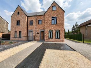 <h3><span>Stijlvolle halfopen pastorijwoning met praktijkruimte, 4 slaapkamers, garage en zonnige tuin op bijna 10 are</span></h3><p><span>Deze recente halfopen pastorijwoning combineert een tijdloze architectuur met hedendaags wooncomfort, een doordachte indeling en een uitstekende energiezuinigheid. Gelegen op een mooi perceel van bijna 10 are, biedt deze woning een uitzonderlijke hoeveelheid ruimte en tal van mogelijkheden voor gezinnen, zelfstandigen of wie op zoek is naar levenslang wooncomfort.</span></p><p><span>Via de ruime inkomhal krijgt u toegang tot de verschillende leefruimtes. Vooraan bevindt zich een afzonderlijke praktijk-, kantoor- of hobbyruimte, ideaal voor zelfstandigen of wie graag van thuis uit werkt. Daarnaast is er een gastentoilet aanwezig.</span></p><p><span>De lichtrijke leefruimte vormt het hart van de woning en geniet dankzij de grote raampartijen van een overvloed aan natuurlijk licht en een mooi zicht op de tuin. Aansluitend bevindt zich de ruime leefkeuken, die desgewenst afgesloten kan worden met stijlvolle schuifdeuren. De keuken biedt niet alleen veel werk- en opbergruimte, maar staat eveneens in directe verbinding met het terras en de tuin.</span></p><p><span>Achter de keuken bevindt zich een praktische doorgang met de technische ruimte, voorzieningen voor wasmachine en droogkast en een extra douche. Opvallend is hoe vooruitstrevend deze woning destijds werd ontworpen. Dankzij de aanwezigheid van een slaapkamer, toilet en douche op het gelijkvloers is gelijkvloers wonen perfect mogelijk, wat de woning ook op langere termijn bijzonder comfortabel maakt.</span></p><p><span>Op de eerste verdieping bevinden zich drie ruime slaapkamers en een moderne badkamer uitgerust met een inloopdouche, toilet, dubbele lavabo en een stijlvol badkamermeubel.</span></p><p><span>De volledig afgewerkte zolderverdieping, bereikbaar via een vaste trap, biedt een enorme meerwaarde. Hier werd een volwaardige extra woonruimte gecreëerd met een ruime slaapkamer, een eigen kitchenette en een aparte badkamer met douche en toilet. Ideaal als gastenverblijf, zorgunit, tienerkamer, kangoeroewoning of voor inwonende familie.</span></p><p><span>Ook op technisch vlak voldoet deze woning aan de verwachtingen van vandaag. Zo beschikt ze over vloerverwarming, 18 zonnepanelen, een ventilatiesysteem en aluminium ramen met driedubbele beglazing. Deze duurzame voorzieningen zorgen voor een aangenaam wooncomfort en een energiezuinige levensstijl.</span></p><p><span>Buiten geniet u van een mooi aangelegd perceel van bijna 10 are waar rust, privacy en ruimte centraal staan. Het ruime terras sluit naadloos aan op de leefruimte en de keuken en vormt de perfecte plek om te ontspannen of gasten te ontvangen. Daarnaast beschikt de woning over een garage en voldoende parkeergelegenheid.</span></p><p><span>De huidige eigenaar, met een sterke bouwtechnische achtergrond, staat bovendien open om eventuele kleine afwerkingspunten in overleg met de koper professioneel in orde te brengen.</span></p><p><span> </span></p><h3><span>Troeven</span></h3><p><span>-Perceel van bijna 10 are<br />-Recente halfopen pastorijwoning<br />-Praktijk-, kantoor- of hobbyruimte<br />-Mogelijkheid tot gelijkvloers wonen<br />-4 volwaardige slaapkamers<br />-Extra woonruimte met kitchenette en badkamer op zolder<br />-Vloerverwarming<br />-18 zonnepanelen<br />-Ventilatiesysteem<br />-Aluminium ramen met driedubbele beglazing<br />-Garage en ruim terras<br />-Instapklaar en uitstekend onderhouden<br />-Energiezuinig wooncomfort<br />-Veelzijdige woning met tal van gebruiksmogelijkheden</span></p><p><span>Een woning die ruimte, comfort en flexibiliteit perfect combineert en klaar is om haar nieuwe eigenaars jarenlang woonplezier te bieden. Ideaal voor gezinnen, zelfstandigen of iedereen die op zoek is naar een kwalitatieve en toekomstgerichte woning in Genk. Info: 0484036892</span></p>
