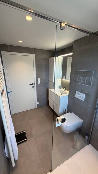 Bent u op zoek naar een instapklaar appartement nabij het centrum van Stabroek? Dit aangename appartement beschikt over een praktische indeling. Via de lift of trap geraak je tot het 3e verdiep. Na de inkomhal met praktische inbouwkasten en apart gastentoilet kom je uit op de ruime, lichte woonkamer op tegelvloer. De keuken met eiland is uitgerust met een vaatwasser, oven, koelkast, kookplaat en dampkap. Verder bevindt zich op deze verdieping een handige berging met aansluitingen voor wasmachine en droogkast. Via de grote schuifraam in de keuken heeft u toegang tot het ruime terras, zuid georiënteerd. De volgende verdieping is ingericht met een ruime slaapkamer, airco en de vernieuwde badkamer met een douche, lavabomeubel en 2e toilet. Ook op het vlak van parkeren biedt dit appartement heel wat comfort. Achter de carport met garagepoort is er een eigen parkeerplek voorzien. Verder is er zowel een overdekte fietsenstalling als fietsenstalling achter slot aanwezig. Het appartement beschikt over een gunstig EPC-label B met een energiescore van 139 kWh/m²/jaar. De elektrische installatie is conform. Kortom een energiezuinig appartement met het gevoel van een woning op centrale ligging. Wenst u meer info? Contacteer ons via 0489 64 87 12