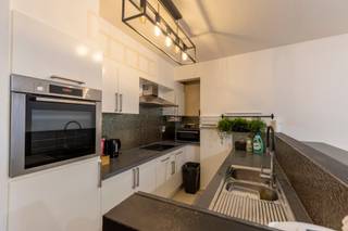 Looking for a prime location in the heart of the city?  
This recent building, constructed in 2009, offers a unique opportunity:  
A modern, high-end apartment with a stunning city view, a bright living room, a semi-open kitchen, 2 comfortable bedrooms, 2 bathrooms (including 1 en-suite), and a separate toilet. The apartment also includes a utility room (boiler room) and a pleasant terrace.  

All windows are double glazed, and the entrance door is reinforced for added security.  
The asking price is €349,000.  
There are individual meters for electricity, gas, and water. Low communal charges of approximately €100/month.

There is an optional parking space available for €18,000, with access from the back of the building (Rijnpoortvest), an electric gate with remote control, and direct lift access into the building.

EPC rating: B

Don’t miss this opportunity — contact us today!