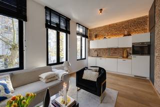 <p><strong>Characterful apartment with terrace </strong></p>
<p>Located between the vibrant streets of 't Zuid, near Marnixplaats, you will find the charming Verbondsstraat. Here, you can enjoy the ideal mix of lively city life and a quiet, characterful environment.</p>
<p>On the first floor of a small-scale building lies this characterful apartment. Upon entering, the generous windows immediately catch the eye, flooding the interior with natural light and creating a sense of space and openness.</p>
<p>Thanks to the high ceilings and exposed brick walls, the apartment exudes a warm and distinctive atmosphere. An attractive bonus is the terrace, accessible from the living area, where you can relax with a drink on beautiful days.</p>
<p>The apartment is move-in ready, featuring a fully equipped open kitchen and a modern ensuite bathroom connected to the bedroom, fitted with a stylish shower.</p>
<p>In 2020, the entire building underwent a complete renovation, ensuring modern living comfort and long-term value.</p>
<p>Finally, the apartment includes a practical private storage room in the basement, and for those wishing to move in completely worry-free, there is the option to purchase the furniture. This allows you to immediately enjoy a fully finished and stylishly furnished apartment.</p>
<p>Character, comfort, and a prime location come together in this move-in-ready apartment. An exceptional opportunity in the heart of 't Zuid.</p>
<p>Contact LISTED today for more information or a visit: +32 3 283 51 51.</p>