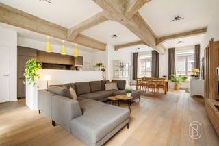 Prachtige instapklare gelijkvloerse loft van 240 m² met ruim terras en parkeerplaats!Gelegen in Ruien, aan de voet van de prachtige Vlaamse Ardennen, bevindt zich deze uitzonderlijk ruime en perfect onderhouden gelijkvloerse loft. Met een bewoonbare oppervlakte van maar liefst 240 m², indrukwekkende plafondhoogtes van 3,30 m en een prachtig terras van 40 m² geniet u hier van een unieke combinatie van ruimte, licht en comfort.Via de inkomhal met gastentoilet bereikt u de royale en lichtrijke leefruimte met open keuken, waar de hoge plafonds zorgen voor een uitzonderlijk ruimtegevoel. Verder beschikt de loft over 3 volwaardige slaapkamers, een comfortabele badkamer met zowel ligbad als douche en een praktische berging.Een absolute extra troef is de halfondergrondse verdieping van maar liefst 60 m². Deze multifunctionele ruimte biedt tal van mogelijkheden als hobbyruimte, wellness met sauna, ontspanningsruimte of extra bergruimte.Buiten geniet u van een heerlijk terras van 40 m², waarvan een gedeelte overdekt is. Daarnaast zijn er 2 private parkeerplaatsen beschikbaar.Dankzij de zonnepanelen van 3.900 W en het uitstekende EPC-label A (78 kWh/m²) geniet u bovendien van een bijzonder energiezuinige eigendom. Er is geen syndicus; enkel het dak en de gevels zijn gemeenschappelijk.De loft is verhuurd sinds 1 juni 2023 en genereert momenteel een maandelijkse huurinkomst van € 1.006,38. Hierdoor vormt deze eigendom ook voor investeerders een interessante opportuniteit. Ideaal voor wie op zoek is naar een uitzonderlijk ruime, instapklare en energiezuinige loft met tal van mogelijkheden, of voor investeerders die een unieke eigendom met bestaande huurinkomsten wensen.Vraagprijs: € 425.000, inclusief één parkeerplaats. Een tweede parkeerplaats kan mee opgenomen worden in de onderhandelingen.Meer info of een bezoek via emmy@immobeguin.beTe koop via Immo Beguin, jouw vastgoedexpert sinds 2009, met kantoren in Ronse, Waregem, Kortrijk, Deinze, Doornik, Lessines, Moeskroen en Nieuwpoort.