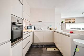 <p><span>Discover this excellently maintained ground floor apartment in Vilvoorde, located in a recent building (2013) with elevator, just outside the center. Thanks to its convenient location, you enjoy easy accessibility, while the nearby Hazeweide Park provides a pleasant green environment.  The large windows provide natural light in the spacious living area. Here there is ample space for a comfortable seating area and a dining area, which together form one harmonious unit with the open kitchen. The kitchen is equipped with all contemporary comforts and features a practical worktop that can also serve as a breakfast nook. Next to the kitchen is a useful storage room with plumbing for a washing machine and dryer, as well as additional storage space next to the dining area. The living area provides access to the spacious and pleasant terrace, where you can enjoy the outdoors in peace and quiet. The entrance hall separates the living and sleeping areas. The apartment has two bedrooms, a modern bathroom with bathtub, shower function and sink, complemented by a separate shower room. Furthermore,  there is a separate toilet. As an added bonus, a closed garage box in the underground parking lot is included in the price. Thanks to its excellent state of repair, practical layout, green surroundings and included garage, this apartment is not only an ideal home, but also an interesting investment opportunity. </span></p><p><span> </span></p>