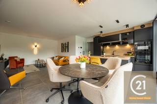 Ontdek dit uitzonderlijke penthouse van 121 m² in de recente Residentie High Five te Vilvoorde gebouwd in 2025, waar hedendaagse architectuur, luxueuze afwerking en baanbrekende energieprestaties perfect samenkomen. Dankzij de volledige zuidoriëntatie, grote raampartijen en het indrukwekkende panoramische terras geniet u de hele dag van een overvloed aan natuurlijk licht en een prachtig groen uitzicht.
De royale leefruimte met stijlvolle open keuken vormt het hart van de woning. De keuken is uitgerust met hoogwaardige toestellen en een elegant kookeiland, ideaal voor wie houdt van koken en gezellig tafelen. Via de grote schuiframen loopt u rechtstreeks naar het ruime zonneterras, een heerlijke plek om in alle rust te ontspannen.
De ruime slaapkamer beschikt eveneens over een rechtstreekse toegang tot het terras en wordt aangevuld met een op maat gemaakte dressing. Daarnaast is er een tweede polyvalente kamer die perfect dienst kan doen als slaapkamer, bureau of hobbyruimte. Verder beschikt het appartement over een luxueuze douchekamer, een afzonderlijk toilet, een volledig ingerichte wasruimte, een vestiaire met design glazen deuren, een gemeenschappelijke fietsenberging en een privatieve buitenberging.
Dit penthouse behoort tot de absolute top op vlak van energiezuinigheid. Met een EPC A, een uitzonderlijk E-peil E3, een warmtepomp, zonnepanelen, vloerverwarming op lage temperatuur, actieve koeling en hoogwaardige thermische en akoestische isolatie geniet u van maximaal wooncomfort én bijzonder lage energiekosten. Dankzij de eigen energieproductie bedraagt het geschatte elektriciteitsverbruik slechts ongeveer €20 per maand.
Bij het appartement hoort een extra brede, beveiligde autostaanplaats met laadpunt voor een elektrische wagen, aan te kopen voor €30.000. De gemeenschappelijke kosten bedragen slechts €85 per maand, inclusief syndicus, gebouwverzekering en onderhoud.
Een bijkomende troef is dat dit appartement verkocht wordt onder het gunstige nieuwbouwregime, zonder 21% btw, met bovendien de mogelijkheid om onder bepaalde voorwaarden te genieten van het verlaagde btw-tarief van 2%. Daarnaast profiteert u nog van de resterende 10-jarige structurele garantie van de projectontwikkelaar.
Gelegen op een strategische locatie nabij Brussel, belangrijke invalswegen, openbaar vervoer en alle dagelijkse voorzieningen, vormt dit instapklare penthouse een zeldzame opportuniteit voor wie op zoek is naar een exclusieve woning.