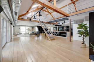 <p>In een historisch gebouw met uitgesproken industrieel karakter aan de Van de Wervestraat, op een boogscheut van Park Spoor Noord en het Antwerpse Eilandje, bevindt zich deze uitzonderlijk ruime en karaktervolle loft. Gelegen in het rustige binnengebied combineert dit unieke eigendom authentieke elementen, royale volumes en een bijzonder flexibele indeling.<br />Via de inkomhal met vestiaire en gastentoilet betreden we de indrukwekkende leefruimte, volledig afgewerkt met parket en gekenmerkt door een aangename plafondhoogte. De ruime industriële keuken is volledig uitgerust met onder meer een stoomoven, hete luchtoven, inductiekookplaat en één gaskookpit, koelkast, diepvries en vaatwasser. Vanuit de leefruimte is er toegang tot twee aangename terrassen, aan de voor- en zijkant van de loft, beide met een gunstige zuidoriëntatie.<br /><br />Een industriële trap leidt naar de mezzanine, waar zich twee ruime slaapkamers bevinden. Aansluitend aan de leefruimte vinden we een praktische was- en technische berging en een royale, centraal gelegen badkamer met groot ligbad, inloopdouche, dubbele lavabo en toilet. De aansluitende inloopdressing met ingemaakte kasten zorgt voor extra comfort en opbergruimte. Vanuit de inkomhal is bovendien een bijkomende slaapkamer bereikbaar, voorzien van dubbele ramen die rechtstreeks toegang geven tot één van de terrassen.<br /><br />Een bijzondere extra troef is het afzonderlijke gedeelte dat via een wenteltrap bereikbaar is. Dit gedeelte beschikt over een eigen leefruimte, (rudimentair) keukenblok, douchekamer met toilet en een ruime kamer op de bovenverdieping kan dit gedeelte perfect functioneren als aparte studio, gastenverblijf, werkruimte of bijkomende slaapvertrekken. Hierdoor leent de loft zich eveneens uitstekend tot co-housing of een combinatie van wonen en werken.<br /><br />Tot slot vormt de ondergrondse autostaanplaats een belangrijke meerwaarde en zorgt deze voor extra comfort op deze centrale Antwerpse locatie. Deze staanplaats is bij aan te kopen.<br />Een unieke loft voor wie op zoek is naar ruimte, industrieel karakter, buitenruimte en tal van indelingsmogelijkheden op een uitstekende locatie nabij Park Spoor Noord en het Eilandje.<br /><br />Interesse in deze unieke loft?<br />Contacteer ons via 03 337 50 70 of info@vbvastgoed.be voor meer info of een bezoek ter plaatse.</p>