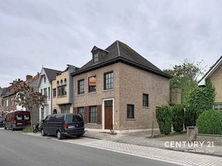 Deze stevige halfopen bebouwing in de Pastoriestraat te Sint-Andries combineert een karaktervolle uitstraling met ruimte en tal van mogelijkheden. De ramen in pastoriestijl geven de woning een tijdloos karakter, terwijl de praktische indeling en de ruime buitenomgeving heel wat troeven bieden.<br /><br />Via de inkomhal met trap en vestiaire komt u in de woonkamer, aansluitend op een veranda. Verder beschikt het gelijkvloers over een afzonderlijke, ruime keuken, een praktische wasplaats/berging en een apart toilet.<br /><br />Op de eerste verdieping bevinden zich drie slaapkamers en een badkamer met toilet. De zolder is bereikbaar via een zolderluik en biedt extra bergruimte of mogelijks slaapkamer mits voorzien vaste trap.<br /><br />Een bijzondere troef is de zijdelingse oprit die toegang geeft tot de achterliggende garagebox en twee ruime bijgebouwen. Deze bieden tal van mogelijkheden voor opslag, hobby's of een atelier. Achteraan bevindt zich bovendien een zeer grote tuin, ideaal voor wie houdt van groen, rust en ruimte.<br /><br />Gelegen in Sint-Andries, met winkels, scholen en openbaar vervoer in de omgeving, biedt deze eigendom een interessante combinatie van een praktische woonlocatie en uitzonderlijk veel ruimte rondom de woning.<br /><br />Een karaktervolle woning met drie slaapkamers, ruime bijgebouwen en een grote tuin — ideaal voor wie op zoek is naar ruimte en mogelijkheden in Brugge.