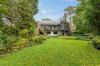 <p>Moderne, vrijstaande villa met een riante leefruimte, kantoor en prachtige tuin.</p>
<p>In een residentiële en rustige omgeving bevindt zich deze mooie, moderne vrijstaande villa, gelegen op een royaal perceel van 2.004 m² met een straatbreedte van circa 42 meter. De woning onderscheidt zich door haar ruime indeling, grote glaspartijen, duurzame materialen en veelzijdige gebruiksmogelijkheden. Dankzij de uitzonderlijk ruime bureelruimte is deze villa bijzonder geschikt voor wie comfortabel van thuis uit wil werken of een vrij beroep wenst uit te oefenen.</p>
<p>Op het gelijkvloers verwelkomt u een ruime inkomhal met Belgische blauwsteen als vloerbekleding. Links bevindt zich de trap naar de bovenverdieping en het gastentoilet met handenwasser. Achteraan bevindt zich een ruime kamer, momenteel ingericht als dressing, die de mogelijkheid biedt om een bijkomende slaapkamer te creëren. De badkamer is uitgerust met een douche en lavabomeubel. Naast de badkamer bevindt zich de slaapkamer met ingemaakte kasten en aansluitend een douchecel en lavabo. Verder zijn er nog een praktische wasplaats, een berging met de verwarmingsinstallatie, van hieruit heeft u toegang naar buiten en een inpandige garage met carport.</p>
<p>De eerste verdieping vormt het hart van de woning en biedt een bijzonder ruime en lichtrijke leefruimte, harmonieus ingedeeld in een eetplaats en een gezellige zithoek met haard. De massieve eikenhouten parket van 22 mm dik en de hoge glaspartijen over de volledige lengte zorgen voor een warme, moderne uitstraling en een overvloed aan natuurlijk licht.</p>
<p>Via een dubbele schuifdeur bereikt u het ruime terras van ongeveer 30m², afgewerkt met bankirai planken en voorzien van verlichting, een elektrisch bediende zonneluifel en een riante ijzeren draaitrap die rechtstreeks toegang geeft tot de tuin. De open keuken sluit naadloos aan op de leefruimte en geniet van een mooi uitzicht op het groen. Ze is uitgerust met boven- en onderkasten, een koelkast, oven, vaatwasser, kookplaat met geïntegreerde afzuiging en spoelbak met aansluitend de berging/bijkeuken en aparte toiletruimte.</p>
<p>Aan de linkerzijde van de woning bevindt zich een uitzonderlijk ruime bureelruimte van circa 50m². De massieve eikenhouten parket van 22 mm dik, de talrijke hoge glaspartijen en het panoramische uitzicht over de tuin en de omgeving creëren een inspirerende werkomgeving. De ruimte beschikt bovendien over een elektrische zonneluifel en airco. Deze polyvalente ruimte biedt tal van mogelijkheden voor thuiswerk, een kantoor aan huis of de uitoefening van een vrij beroep of masterbedroom.</p>
<p>Op de tweede verdieping bevindt zich een zolderruimte van circa 90 m² die nog verder afgewerkt kan worden. Hierdoor beschikt de woning over bijkomend potentieel voor uiteenlopende invullingen, afhankelijk van uw wensen en behoeften.</p>
<p>Ook buiten heeft deze villa heel wat te bieden. De mooie aangelegde en volledig omheinde tuin vormt een groene oase van rust en privacy. Naast een groot tuinhuis beschikt het perceel over een ruim overdekt terras onder de huidige bureelruimte, een serre en vijvers die bijdragen aan het karaktervolle geheel.</p>
<p>Dankzij de ruime parkeermogelijkheden aan de voorzijde, de inpandige garage, de carport en de flexibele indeling is deze villa niet alleen ideaal voor wie op zoek is naar een comfortabele gezinswoning, maar ook bijzonder interessant voor zelfstandigen of vrije beroepen die wonen en werken op één locatie willen combineren. Bovendien is er een laadpaal aanwezig aan de carport.</p>
<p>Tot slot is de volledige villa, met uitzondering van de garage, voorzien van een kruipkelder. Alle achterramen op het gelijkvloers beschikken over afsluitbare rolluiken.<br /><br />Extra info: unieke villa I deels gereoveerd in 2017 en 2020 I waterput aanwezig diepte ca. 60 meter I <span>EPC 370 kWh/ (m² jaar) label D I infoplicht: in aanvraag I watertoets: P-score: D I G-score: D.</span></p>