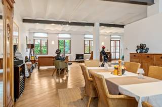 <p>Located in a stately historic building, this exclusive loft offers an exceptional blend of character, space and contemporary comfort. The authentic architecture and serene inner courtyard create the perfect setting for a unique living experience where history and modern elegance come together seamlessly.</p>
<p>Take the lift to the first floor, where this one-of-a-kind apartment awaits you. High ceilings, quality wooden plank floors, large windows and cast-iron columns create a harmonious living space full of character and charm. Adjacent to the living area is the kitchen, thoughtfully designed and equipped to meet modern-day comfort standards. The apartment further features a spacious bedroom (19 m²) and, of course, a bathroom fitted with a bathtub, shower and washbasin in a vanity unit.</p>
<p>As the icing on the cake, a generous terrace of no less than 13 m² completes the property – the perfect place to unwind and enjoy peace and tranquillity in the heart of the vibrant city.</p>
<p>Will you become the new owner of this stylish residence with a truly distinctive identity?</p>
<p>No more parking stress? Possibility to purchase a parking space for €25,000.00.</p>
<p>Monthly costs: €126.66 (including insurance, maintenance of the common areas, garden maintenance, lift, water and electricity for the common areas, syndic, etc.). The provision is charged quarterly with an annual settlement.</p>
<p>Technical details: EPC label B! Basement storage available, individual gas central heating via a condensing boiler, mainly high-efficiency wooden glazing. Lift available!</p>
<p>Urban planning information pending, soil certificate available. Asbestos-safe (but possibly not asbestos-free). The property is not located in a flood-risk zone (P- and G-score C). Renovation obligation does not apply.</p>