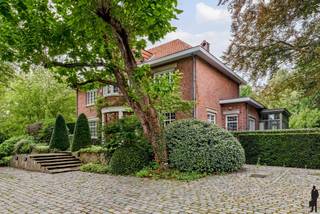 <strong>Charmante villa met prachtige parktuin op een perceel ca. 4.309 m² te Brasschaat! </strong><br /><strong>Een karaktervolle unieke volledig omheinde villa met automatische toegangspoort, ruime oprit en prachtige tuin!<br /><br /></strong><br /><strong>De gelijkvloerse verdieping:<br /></strong>- Een inkomhal op marmeren vloer, met een ruime vestiaire met ingemaakte kasten en gastentoilet met afzonderlijk handenwasser<br />- Een bibliotheekruimte met op maat gemaakte houten kasten, bereikbaar via dubbele deur<br />- Een woonkamer op parketvloer met indrukwekkende open haard en zicht op de tuin<br />- Een orangerie/serre met prachtige lichtinval en zicht op het overdekt zwembad <br />- Een eetkamer op tegelvloer met dubbele deuren naar het terras<br />- Een recente keuken (2020) met Siemens-inbouwtoestellen (inductiekookplaat, microgolf, vaatwasser, koelkast, vriezer), dubbele spoelbak<br />- Een bijkeuken met extra kastruimte en toegang tot het terras<br />- Een slaapkamer/bureauruimte met aparte toegangsdeur naar buiten, betegelde vloer, eigen douchekamer met lavabo, toilet, douche en handdoekradiator<br /><strong><br />Kelderverdieping (ca. 100 m²) </strong>(volledig onderkelderd): ruime kelder met meerdere compartimenten voor berging en/of wijnkelder, technische ruimte met CV-installatie (Vaillant), boiler en tellers voor gas, water en elektriciteit, aansluitingen voor wasmachine en droogkast, spoelbak en praktische voorzieningen (geïsoleerd plafond en toegang tot kruipkelder), alsook een ondergrondse garage met plaats voor 4 auto's en twee automatische sectionaalpoorten.<br /><br /><strong>De eerste verdieping:<br /></strong>- Een nachthal op houten vloer<br />- Een douchekamer met lavabo, toilet en handdoekradiator<br />- Twee slaapkamers met houten vloer, verbonden met elkaar – ideaal als kinder- of logeerkamers<br />- Een vierde slaapkamer op parketvloer<br />- Een hoofdslaapkamer met ingemaakte kasten, parketvloer, eigen badkamer voorzien van ligbad, douche, lavabo en apart toilet en eigen dressing met doorgang naar de nachthal<br /><br /><strong>Tweede verdieping (zolderverdieping):</strong><br />- Een polyvalente ruimte ideaal als extra slaapkamer, hobbykamer of logeerkamer met lavabo<br />- Twee afzonderlijke zolderkamers (ca. 17 en 20 m²) onder het dak – volledig geïsoleerd<br /><br /><strong>Tuin &amp; buitenruimte:</strong><br />- Volledig omheind perceel met automatische poort en ruime oprit met meerdere parkeerplaatsen<br />- Zonnig terras met voldoende buitenverlichting<br />- Prachige parktuin, omgeven door volwassen bomen en sierlijke aanplantingen: absolute privacy gegarandeerd<br />- Overdekt, verwarmd (warmtepomp) zwembad (ca. 4 m x 12 m) met aparte douchekamer<br />- Orangerie/serre met zicht op de tuin en zwembad: een ware oase van rust<br />- Fruitgaard, kippenren, speelhoek, prachtige rozenperken, vijver en extra bijgebouw<br /><br /><strong>Algemeen:</strong><br />- Verwarming via radiatoren en convectoren op gas (Vaillant 2022)<br />- Kwalitatieve materialen zoals marmer, parket en maatwerk in hout<br />- Toplocatie in Brasschaat, nabij scholen, winkels, openbaar vervoer en uitvalswegen<br />- Tal van mogelijkheden voor zelfstandige beroepsactiviteit, kangoeroewonen of grote gezinnen<br />- Recente vernieuwingen met aandacht voor isolatie (gunstig EPC): hoofdak en plat dak voorzien van isolatie, vloer gelijkvloers eveneens voorzien van isolatie (2025) <br />- Alarmsysteem, vliegenhorren en regenwaterput aanwezig
