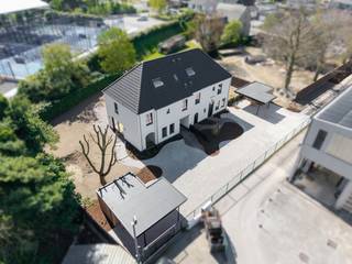 In tweede lijn, omgeven door rust en groen, bevindt zich deze uiterst kwalitatieve nieuwbouwwoning die ruimte, licht en verfijning moeiteloos combineert. De woning ademt een landelijke sereniteit, verfijnd vertaald naar hedendaags wooncomfort met een uitgesproken high-end afwerking. Elk detail werd met zorg gekozen — kosten noch moeite werden gespaard — en enkel duurzame, hoogwaardige materialen vonden hier hun plaats. Een woning die vandaag al klaar is voor morgen.<br /><br />Deze woning betreft de rechtse woning bij vooraanzicht (lot 2).<br /><br />De architectuur en indeling zijn doordacht tot in de finesse: royale leefruimtes, een optimale lichtinval dankzij grote glaspartijen en een volledige harmonie tussen binnen en buiten, met zicht en toegang tot de tuin rondom.<br /><br />Ook de buitenaanleg wordt volledig afgewerkt met oog voor esthetiek en functionaliteit. Oprijlaan van 35 meter, voortuin, inkompad, terras en parkeerstroken worden uitgevoerd in waterpasserende kleiklinkers met organische vormen. In de voortuin bevindt zich een carport met extra tuinberging. Zwarte omheining, betonplint en ericamatten zorgen voor maximale privacy, terwijl achteraan een haag een groene, natuurlijke afsluiting vormt.<br /><br />Indeling gelijkvloers:<br /><br />- Royale inkomhal met gastentoilet<br />- Zeer lichtrijke leefruimte met zit- en eethoek<br />- Open, volledig uitgeruste keuken met volkeramisch werkblad met afgeronde hoeken, dubbele spoelbak, inductiekookplaat, telescopische dampkap, koelkast, oven, microgolf en vaatwasmachine<br />- Praktische wasplaats/berging<br />- Afgesloten bureauruimte met stijlvolle stalen deuren<br /><br />Verdieping:<br /><br />- Ruime nachthal<br />- Apart toilet<br />- Drie volwaardige slaapkamers, waaronder een master bedroom met ensuite dressing<br />- Luxe badkamer met ligbad, dubbele lavabo en inloopdouche<br /><br />Via een vaste trap bereikt u de zolderverdieping, waar reeds Velux-ramen voorzien zijn en uitbreidingsmogelijkheden bestaan voor extra kamers.<br /><br />Extra troeven:<br /><br />- Lucht-water warmtepomp met vloerverwarming op gelijkvloers én verdieping<br />- Regenwaterput van 10.000 liter<br />- Zwarte PVC-ramen (RAL 9005) met kleinhouten en dubbele beglazing<br />- Ventilatiesysteem type D<br />- Conforme elektriciteit<br />- Volledige voorbereidingen voor internet, coax, zonneluifel, screens, thuisbatterij, koelcel en extra douche op het gelijkvloers<br />- Volkeramische vloeren, massief parket in de leefruimte en laminaat op de verdieping<br />- Venstertabletten in arduin<br />- Vaste eiken trappen<br /><br />Kortom: een uitzonderlijk luxueus woonproject dat klasse en tijdloze elegantie uitstraalt, versterkt door de prachtig gekaleide gevels.
