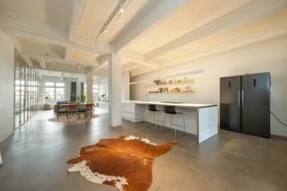 <p><span>ANTWERP – Eilandje: Move-in-ready industrial loft with terrace and parking space (EPC-A)</span></p><p><span> </span></p><p><span>DESCRIPTION:</span></p><p><span> </span></p><p><span>This move-in-ready loft of approx. 163 m² is situated on the 3rd floor of a characterful former warehouse in Antwerp, just a stone’s throw from Park Spoor Noord and the Eilandje.</span></p><p><span>The industrial architecture, robust load-bearing structures and sleek finishes give the loft a distinctive character.</span></p><p><span>At the front is the open-plan living area, where the high ceilings, wooden parquet flooring and large windows create a particularly spacious feel, plenty of natural light and an unobstructed view.</span></p><p><span>The off-white steel doors provide a refined contrast to the building’s raw aesthetic.</span></p><p><span>Adjacent to this is the open-plan kitchen, fitted with a large kitchen island, ample cupboard space and a gas hob. The concrete-effect flooring in the kitchen and the area behind it reinforces the loft’s industrial character.</span></p><p><span>The loft also features three bedrooms, with fitted wardrobes that contribute to a sleek and practical design.</span></p><p><span>The bedroom at the front is currently set up as an office.</span></p><p><span>At the rear is a bedroom with direct access to the spacious terrace, overlooking the green courtyard garden. A peaceful spot right in the heart of the city.</span></p><p><span>The bathroom completes the property.</span></p><p><span> </span></p><p><span>The communal courtyard garden is a delightful feature, whilst the lift and parking space provide added convenience.</span></p><p><span>The location is also particularly appealing: in a lively Antwerp neighbourhood, surrounded by art galleries, trendy restaurants and bars, and revitalised city squares, with the bustling city life within easy reach.</span></p><p><span>A characterful loft where space, light and industrial architecture come together, with peaceful green surroundings as an added bonus.</span></p><p><span> </span></p><p><span>A parking space can be purchased as an option for €40,000.</span></p><p><span> </span></p><p><span>SPECIAL FEATURES:</span></p><p><span> </span></p><p><span>EPC rating A!</span></p><p><span>Solar panels installed</span></p><p><span>Ready-to-move-in loft of approx. 163 m²</span></p><p><span>Industrial architecture with robust supporting structures and distinctive materials</span></p><p><span>Pleasant terrace overlooking the green courtyard garden</span></p><p><span>Communal courtyard garden as a peaceful oasis in the city</span></p><p><span>Car parking space within the building</span></p><p><span>Lift available</span></p><p><span>Easy access by public transport</span></p><p><span>Surrounded by restaurants, shops and urban amenitie</span></p><p><span> </span></p>