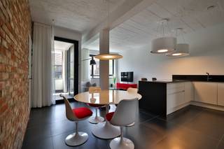This luxury apartment with industrial accents is located in an old toy factory in Mortsel where old and new elements are interwoven.Living room and...