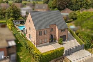 In een rustige straat in Rumst, met een prachtig en open zicht op het omliggende groen, bevindt zich deze moderne en energiezuinige villa. De woning werd gebouwd in 2010 en combineert een hoogwaardige afwerking, royale volumes en hedendaags wooncomfort op een prachtig zuidwest gericht perceel van 10a 60ca.<br /><br />Met een bewoonbare oppervlakte van maar liefst 330 m² biedt deze instapklare villa alle ruimte voor een comfortabel gezinsleven. Bovendien werd de woning recent nog energetisch geoptimaliseerd, wat resulteert in een bijzonder energiezuinige en toekomstgerichte woning, voorzien van airco's, zonnepanelen, thuisbatterij en laadpaal.<br /><br />Via de ruime inkomhal betreedt u de lichtrijke leefruimte, waar grote raampartijen en hoogwaardige materialen zorgen voor een luxueuze en aangename woonbeleving. Aansluitend bevindt zich de volledig geïnstalleerde keuken, uitgerust met onder meer een wijnfrigo en een kwalitatief gasvuur. De keuken geeft rechtstreeks toegang tot het volledig overdekte terras, waar u in alle rust kunt genieten van het uitzicht over de zonnige tuin en het zwembad. Verder beschikt het gelijkvloers over een ruime wasplaats, berging en inpandige garage.<br /><br />Op de eerste verdieping bevinden zich vier volwaardige slaapkamers, twee badkamers, waarvan één met sauna, en een ensuite dressing. De master bedroom beschikt bovendien over een eigen balkon. Ook de tweede verdieping werd volledig ingericht en biedt tal van mogelijkheden. Deze verdieping kan dienen als twee ruime slaapkamers, maar leent zich eveneens uitstekend als ruime bureau-, hobby- of polyvalente ruimte.<br /><br />Deze moderne villa combineert een uitstekende ligging met een hoogwaardige en luxueuze afwerking, uitstekende energetische prestaties en een prachtige groene omgeving. Een volledig instapklare woning waar comfort, kwaliteit en privacy centraal staan.<br /><br />Voor meer informatie of een bezoek kunt u ons steeds contacteren op het nummer 015/21.21.21 of via olivier.lievens@imovastgoed.be.<br />Vraagt u zich af wat uw eigen woning waard is? Neem dan gerust contact op voor een gratis waardebepaling.