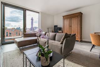 Dit tijdloze appartement werd opgetrokken in 2018 en is gelegen op de derde en dus bovenste verdieping waardoor het een aangenaam uitzicht geeft over het volledige woonerf en de gemeenschappelijke tuin. De indeling is als volgt: inkomhal, 2 slaapkamers, apart toilet, badkamer met dubbele wastafel en inloopdouche, gezellige woonkamer met schuifraam naar het terras toe, berging met plaats voor wasmachine, droogkast en diepvries en een keuken met keramische kookplaat, combi oven/microgolf, koelkast en natuurlijk een afwasmachine. Het appartement heeft een ruim zuid-west georiënteerd terras wat ervoor zorgt dat het vanaf 's middags tot 's avonds laat heerlijk vertoeven is in het zonnetje. Op de ondergrondse verdieping bevindt zich een autostaanplaats. Deze is inclusief in de prijs. TOF APPARTEMENT OP EEN RUSTIGE LOCATIE, TOCH PAL IN HET CENTRUM!