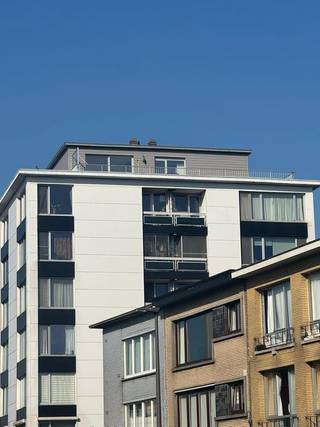 Zonnig dakappartement (84 m²) met ruim zuidgericht terras (43 m²) en panoramisch uitzicht.<br /><br />Het appartement beschikt over 2 volwaardige slaapkamers en 2 badkamers en werd volledig gerenoveerd.<br /><br />Slaapkamer 1 (14m2) heeft een en-suitebadkamer met inloopdouche, toilet en lavabo. Slaapkamer 2 (11m2) beschikt over een aparte badkamer met inloopdouche, toilet en lavabo.<br /><br />De open keuken is uitgerust met een grote koelkast met diepvriezer, combi-oven, inductiekookplaat, vaatwasser en was-droogmachine.<br /><br />De ruime leefruimte met grote raampartijen zorgt voor veel lichtinval en is afgewerkt met parketvloer, open haard en airconditioning.<br /><br />Superisolerende ramen. Eigen verwarmingsketel. Fietsenberging aanwezig in het gebouw.<br /><br />Momenteel krijgt het appartement nog zijn finishing touch. Beschikbaar vanaf april.<br /><br />Huur bedraagt €1195 per maand. <br />Algemene kosten zijn €125 per maand. Dit inclusief waterverbruik.