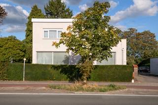 <p><strong>Vrijstaande woning op 668 m² met diepe tuin en ruime garage in Hove</strong></p>
<p>Aan de Mechelsesteenweg in Hove staat deze vrijstaande woning uit 1940. Ze heeft een strakke architectuur met platte daken en ligt op een perceel van 668 m². Het is een degelijke woning met veel ruimte en een uitzonderlijke buitenruimte, klaar om naar eigen smaak te moderniseren.</p>
<p><strong>Indeling</strong><br />Je komt binnen in een lichte inkomhal met een natuurstenen vloer. De woon- en eetkamer liggen in elkaars verlengde, met novylon op de vloer, grote raampartijen en airco. De keuken met tegelvloer is volledig ingericht en heeft een eethoek. Aansluitend ligt de veranda met aansluiting voor was- en droogmachine en rechtstreekse toegang tot het overdekte terras. Op het gelijkvloers is er ook een bureau dat eventueel als slaapkamer kan dienen.</p>
<p>Op de verdieping liggen vier slaapkamers en een badkamer met ligbad, wastafelmeubel en toilet. Onder de woning is er een ruime kelder, onderverdeeld in vier compartimenten.</p>
<p><strong>Buiten</strong><br />Het overdekte terras komt uit op een diepe, rustige tuin die door hagen en oude bomen is afgeschermd. Achteraan op het perceel staat een ruime garage van 50 m², bereikbaar via de oprit naast de woning. Er is ook plaats om meerdere wagens op eigen terrein te parkeren.</p>
<p><strong>Troeven:</strong> vrijstaand, 668 m² grond, 4 à 5 slaapkamers, ruime kelder, garage van 50 m², diepe tuin met overdekt terras.<br /><br />EPC:364KwH/m²/jaar.</p>
<p><strong>Interesse? Contacteer ons voor een bezoek.</strong></p>