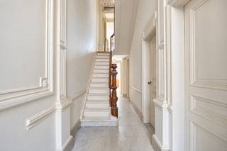 Elegant townhouse with south-facing garden
Ideally located in Antwerp South, this impressive neoclassical townhouse has been extensively renovated since 2023 while carefully preserving its authentic character.
The spacious entrance hall with high ceilings, original ornaments and marble flooring leads to the living areas with oak herringbone parquet and original marble fireplaces.
The renovated walnut kitchen features composite worktops, Mortex flooring, a breakfast bar and direct access to the private south-facing garden with several terraces.
The first floor offers 2 spacious bedrooms and a luxurious bathroom with double marble washbasin, walk-in shower and bathtub. The mezzanine is being prepared for a second bathroom. The second floor comprises 2 bedrooms and a dressing room. The third floor provides another 2 bedrooms and a home office with bespoke walnut cabinetry.
The property also benefits from a finished attic of approx. 30 m² and a substantial basement of approx. 95 m² with direct garden access.
Highlights:
• 6 bedrooms
• Office
• South-facing garden
• Authentic features and high-quality renovation.
Technical:
• favourable EPC rating
• compliant electrical installation
• asbestos-safe/free.
Purchasing as your sole and first home? You may benefit from the reduced 2% registration tax rate.
Info: 03/345.88.99.
