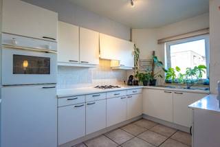 Dit goed onderhouden appartement, gebouwd in 1995, combineert een praktische indeling met een gunstige ligging. Via de inkomhal komen we in de ruime en lichtrijke woonkamer met open keuken. De keuken is uitgerust met een gasvuur, dampkap, ingebouwde koelkast en oven. Verder beschikt het appartement over twee slaapkamers, een praktische berging met aansluiting voor de wasmachine, een apart gastentoilet en een nette badkamer met ligbad en lavabomeubel. Een extra troef is het zonnige, zuidwest georiënteerde terras. Daarnaast beschikt het appartement over een private kelderberging, ideaal voor extra opslagruimte. Op energetisch vlak scoort het appartement uitstekend, met een EPC-score van slechts 97 kWh/m² (label A). Het appartement is bovendien asbestveilig en alle nutsvoorzieningen zijn individueel. Er is tevens de mogelijkheid om een garage bij aan te kopen, bereikbaar via de Papenweg. Dankzij de centrale ligging bevinden scholen, winkels en openbaar vervoer zich op wandelafstand. Door de combinatie van twee slaapkamers, een gunstig EPC en de centrale ligging is het appartement zowel interessant voor eigen bewoning als als opbrengsteigendom. Wenst u meer informatie en/of een bezichtiging? Contacteer ons via 03 568 03 03 of lauren@vastgoed03.be.