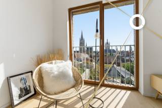 Ontdek dit schitterend ingerichte appartement van 102 m² op de 4e verdieping, aan de voorkant van het gebouw met zicht over heel Ieper. <br /><br />Hoogtepunten:<br /><br />*Perfecte Ligging: Midden in het centrum, maar omgeven door rustgevende binnentuinen.<br /><br />*Ruim Terras: 18 m² groot, ideaal voor zonnige middagen en avonden. Er is ook nog een terras van 5 m² ter hoogte van de slaapkamer en badkamer.<br /><br />*Uitstekende Voorzieningen: Ondergrondse parkeergarage met plaats voor 130 auto's en een handige fietsenstalling met lift.<br /><br />*Modern Comfort: Voorzien van uitstekende isolatie, zonnepanelen en regenwaterrecuperatie voor een duurzaam en comfortabel leven.<br /><br />*Ruimte en Groen: Diverse open ruimtes met verhardingen, waterpartijen en groene tuinen zorgen voor een aangename leefomgeving.<br />Architectonisch Meesterwerk:<br /><br />*Ontwerp: Drie torens die boven drie bouwlagen uitsteken, ontworpen door de gerenommeerde architectenbureaus Robbrecht en Daem en URA Architects.<br />Stijl: Sober modern met elementen zoals bakstenen, houten ramen en balustrades, die perfect harmoniëren met de omgeving en rust uitstralen.<br />Een Oase van Rust in de Stad:<br /><br />*Groene Uitzichten: Geniet van prachtige uitzichten op groene tuinen en de omgeving.<br />Stadsleven met Voordelen: Combineer het bruisende stadsleven met de rust en sereniteit van een exclusieve woonomgeving.<br /><br />*6 % btw mogelijk<br /><br />Conclusie:<br />Gloria biedt een unieke kans om te genieten van luxe, comfort en rust, midden in de stad. Dit appartement is een oase van kalmte, waar je kunt profiteren van alle voordelen van stedelijk wonen zonder in te boeten aan rust en privacy. Mis deze kans niet om jouw droomwoning te ontdekken in het hart van de stad!