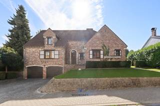 Op een ruim perceel van 840 m² ontdekt u deze villa die charme en comfort combineert. De woning is volledig onderkelderd en biedt tal van extra mogelijkheden.<br /><br />De royale inkomhal verwelkomt u in de lichtrijke leefruimte met authentieke open haard, aansluitend een aparte keuken. De badkamer is uitgerust met een Italiaanse inloopdouche en een dubbele lavabo met stijlvol blad. Verder zijn er vier ruime slaapkamers van ca. 12 m², 16,5 m², 15,5 m² en 19 m².<br /><br />De bovenverdieping kan nog volledig worden afgewerkt tot een extra woonlaag met een luxueuze master bedroom met ensuite badkamer en dressing, aangevuld met een bijkomende kamer. Dankzij de plafondhoogtes tot 3,5 meter en de royale volumes kunt u uw woonwensen volledig realiseren.<br /><br />De zonnige, zuidwestgerichte tuin vormt een oase van rust met zijn prachtige zwemvijver: een ideale plek om te ontspannen en te genieten.<br /><br />Extra troeven: dubbele beglazing, rolluiken, luifel, alarmsysteem, airco en een EPC-label D zonder renovatieplicht. Bovendien is dit pand geschikt voor uitbreidingsmogelijkheden.<br /><br />Dit unieke eigendom met authentieke en luxueuze elementen uit de jaren ’80 is een echte buitenkans voor wie op zoek is naar een ruime villa met potentieel.<br /><br />Niet te missen parel! Plan snel uw bezoek via www.woonvast.be<br /> of contacteer Morgane via morgane@woonvast.be<br /> of op 0498 60 61 75.