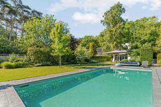 In one of the most sought-after residential areas of Lanaken, you will find this exclusive property where space, tranquility, and refinement are central. With an impressive living experience of 488 m² (source EPC), this house was designed according to a thoughtful total concept in which light, comfort, and sustainability come together harmoniously.<br /><br />The timeless architecture and high-quality finish create a stylish living experience with spacious living areas, large windows, and a strong connection to the beautifully landscaped garden of approximately 1,281 m². Every detail exudes quality and elegance.<br /><br />The property also has a full-fledged basement that offers numerous possibilities, ranging from relaxation space, fitness or hobby room, to additional living or guest accommodation. Thanks to the high-quality finish, this level also forms an integral part of the overall living experience.<br /><br />Furthermore, the house is extremely energy-efficient and fully tailored to contemporary living comfort.<br /><br />An absolute added value is the integrated office with separate access - ideal for liberal professions, home work, or receiving clients in complete discretion.<br /><br />Outside, you can enjoy a mature, low-maintenance garden with various terraces and a stylish pool that guarantees complete privacy. An oasis of tranquility in a green and residential environment.<br /><br />The location is exceptional: quiet and residential, near the Hoge Kempen National Park, Maastricht, and near La Butte aux Bois. An environment where nature, gastronomy, relaxation, and international allure complement each other perfectly.<br /><br />A unique property for those looking for an exclusive living experience in an absolute prime location.<br /><br />Key assets<br />Exceptional residential prime location near La Butte aux Bois<br />488 m² high-quality living experience<br />Plot of 1,281 m²<br />Timeless architecture with thoughtful total concept<br />4 to 5 full-fledged bedrooms<br />Spacious and light-filled living areas<br />Fully finished basement with multifunctional possibilities<br />Office/ practice space with separate access<br />Very energy-efficient house<br />High-quality materials and finishes<br />Large windows and optimal connection to the outside<br />Heated pool with complete privacy<br />Mature landscaped and low-maintenance garden<br />Various sun terraces<br />Quiet, green, and residential environment<br />Near Hoge Kempen National Park and Maastricht<br />Ideal for living, working, and relaxing at the highest level