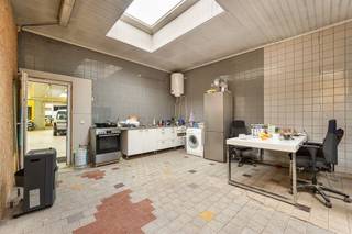 <p><span> </span></p><p><span>Looking for a property with mass’s of space as well as possibilities? This versatile building combines a huge warehouse with multiple residential units in a prime location near the Rivierenhof. Ideal for those who want to combine living and working, or for investors aiming for returns. </span></p><p><span> </span></p><p><span>Living, working or investing</span></p><p><span>According to the latest licensed plans, it involves two apartments, a retail space and a warehouse. Today the ground floor is partly used as an apartment (rented at €1000/month) and there is a spacious warehouse, accessible through a large garage door. </span></p><p><span>The building breathes history – once it served as a meat factory – and you can feel it in the impressive volumes and robust structure. The warehouse extends over a huge area, with several workshops, open spaces and storage areas. Perfect for self-employment, storage, workshops or redevelopment.</span></p><p><span>In addition to the warehouse, the ground floor includes an office, kitchen, sanitary facilities and several multipurpose rooms. </span></p><p><span> </span></p><p><span>Apartments with potential</span></p><p><span>On the second floor, there are two separate entities:</span></p><p><span>At the rear is a studio with an adjacent apartment, currently rented at €500/month.</span></p><p><span>At the front is a spacious apartment of about 100 m² with large terrace. This unit is vacant and needs further finishing – a great opportunity to finalize to your own taste.</span></p><p><span>On the second floor is a ready to move in apartment of approx. 70 m², with living space, kitchen, bedroom and bathroom. Ideal as an additional rental unit or for own occupation.</span></p><p><span> </span></p><p><span>Large warehouse with endless possibilities</span></p><p><span>The absolute showpiece is without a doubt the huge warehouse on the ground floor. The high ceilings, wide spans and large garage door make loading and unloading particularly easy. This volume lends itself perfectly to storage, production, creative interpretation or a combination of living and working under one roof.</span></p><p><span>Thanks to its solid structure and surface area, this property offers numerous redevelopment possibilities, always within the applicable urban development regulations.</span></p><p><span> </span></p><p><span>Green and central in Deurne South</span></p><p><span>You are in a good location here in Deurne-Zuid, near the Rivierenhof. Stores, public transport and approach roads are a short distance away. A strategic location for both residential and professional use.</span></p><p><span>The combination of accessibility, space and layout makes this property particularly interesting for investors, entrepreneurs or large families looking for a lot of space.</span></p><p><span> </span></p><p><span>Advantages</span></p><p><span>multifunctional building; combination of living and working possible; roof insulation; top location in Deurne-South; near Rivierenhof </span></p><p><span> </span></p>