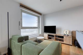 Ontdek dit lichtrijke en energiezuinige appartement op de tiende verdieping van een moderne woontoren aan het Kattendijkdok-Westkaai in Antwerpen...