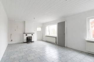 Op een rustige en landelijke locatie aan de Ambachtstraat 21 in Hamont vinden we deze open bebouwing op een perceel van 500 m². De woning wordt omgeven door groen en biedt een aangenaam, open uitzicht over de omliggende weilanden. Ook de Nederlandse grens bevindt zich vlakbij.<br />De woning dateert oorspronkelijk van 1949 en werd volgens de kadastrale gegevens in 2007 voor het laatst grondig gewijzigd. Dankzij de slaapkamer en badkamer op het gelijkvloers is gelijkvloers wonen mogelijk. De ruime, onafgewerkte zolder biedt bovendien heel wat mogelijkheden om de woning verder naar eigen smaak in te richten.<br />Indeling<br />Gelijkvloers:<br />De woning omvat een keuken, een ruime en lichtrijke woonkamer, één slaapkamer, een badkamer en een technische ruimte. Vanuit de technische ruimte leidt een vaste trap naar de bovenverdieping.<br />Verdieping:<br />De onafgewerkte zolderruimte biedt interessante uitbreidingsmogelijkheden. Mits de nodige werken en vergunningen kunnen hier bijvoorbeeld bijkomende slaapkamers, een hobbyruimte of een bureau worden ingericht.<br />Buitenruimte<br />De woning beschikt over een groene buitenruimte met uitzicht op de omliggende weilanden. De landelijke omgeving en het open landschap vormen zonder twijfel een van de grootste troeven van deze eigendom. Daarnaast is er een carport aanwezig.<br /><br />Pluspunten:<br />Rustige en landelijke ligging<br />Open bebouwing<br />Perceeloppervlakte van 500 m²<br />Mooi uitzicht over de omliggende weilanden<br />Gelegen nabij de Nederlandse grens<br />Slaapkamer en badkamer op het gelijkvloers<br />Vaste trap naar de verdieping<br />Ruime onafgewerkte zolder met mogelijkheden<br />Centrale verwarming<br />Zonneboiler aanwezig<br />Carport<br /><br />Perceel- en gebouwscore A: geen overstroming gemodelleerd<br /><br />EPC: 401 kWh/(m² jaar) – label E.<br />De woning valt onder de Vlaamse renovatieverplichting voor residentiële gebouwen. De nieuwe eigenaar dient de woning binnen de wettelijk voorziene termijn energetisch te renoveren (1 punt nodig)<br /><br />Bent u op zoek naar een landelijk gelegen woning die u volledig naar eigen smaak kunt opfrissen en verder kunt afwerken? Contacteer ons dan voor meer informatie of een bezichtiging.
