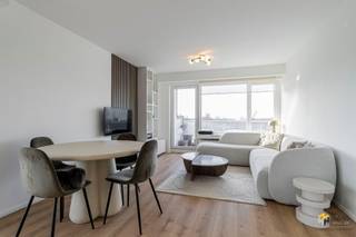 <p><span>Renovated apartment (77 m²) with 2 bedrooms and 2 terraces in Borgerhout.</span></p><p><span> </span></p><p><span>On the border of Borgerhout and Deurne, right across from the Rivierenhof, on the fifth floor of a well-maintained building you will find this bright corner apartment. Thanks to this prime location, you enjoy excellent accessibility by streetcar, bus, velo and car, while the extensive greenery of the Rivierenhof is literally across the street.</span></p><p><span> </span></p><p><span>The apartment is part of a well-maintained building whose roof has been insulated accordingly. The monthly fixed costs are €290 and are all-inclusive, including contribution to the reserve fund — a transparent and worry-free formula. This corner apartment was completely renovated in 2023 with particular attention to detail, choosing quality and durable materials. Thanks to the numerous built-in closets, the available space was optimized, creating a sleek and functional whole. The electricity is compliant, the windows are double-glazed and with a favorable EPC score B, you are assured of energy-efficient living comfort.</span></p><p><span> </span></p><p><span>A corner apartment means maximum light as well as two terraces. You have an east-facing terrace of 4 m² and a spacious south-facing terrace of 11 m², with a view of the Rivierenhof. Enter into the entrance hall with fitted wardrobe. The first bedroom (13 m²) offers a comfortable surface and is located opposite the modern bathroom (5 m²), equipped with a sink and walk-in shower. The toilet is provided separately. The second bedroom (7 m²) is perfectly usable as a dressing room, office or children's room — a flexible space that you can fill to your own needs. The bright living space (29 m²) is the heart of the apartment. Here the custom-made kitchen in dark wood veneer is a real eye-catcher. It combines a stylish look with contemporary comfort and makes cooking and dining an enjoyable experience.</span></p><p><span>Are you looking for a move-in ready apartment? Don't miss this opportunity! Living area 77 m² ref: gross floor pop. For more info or a free estimate visit </span><span><span>www.hansimmo.be</span></span></p><p><span> </span></p>