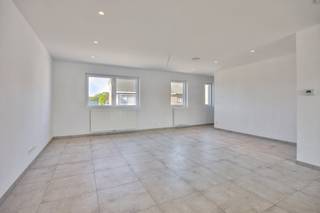 Are you looking for a spacious and energy-efficient new-build apartment in Zonhoven? With approx. 185 m², this stylish triplex apartment from 2022 offers the comfort and feel of a first-floor apartment, combined with the benefits of an apartment. In addition, this property is sold under registration fees instead of 21% VAT.<br /><br />You can reach the house via the private entrance hall with its own staircase. There is a practical storage space on the ground floor. The first floor includes a hall with guest toilet, a bright living room with sitting area and dining area, an open kitchen with a cooking island and high-quality appliances, a storage room and a terrace of approximately 13 m². On the second floor, there are three full bedrooms and a stylish bathroom with a walk-in shower and a second toilet.<br /><br />As an almost energy-neutral (BEN) home, the apartment obtains an EPC label A (49 kWh/m²/year) and is equipped with, among other things, ventilation system D, high-efficiency glazing and a rainwater well. Two private parking spaces are included.<br /><br />Thanks to its central location near shops, schools, restaurants, sports facilities, the E313, the E314 and De Wijers nature reserve, you can enjoy easy accessibility and a green living environment.<br /><br />Register of measures: no<br /><br />These AI visualizations are intended as inspiration. No technical specifications, urban planning regulations, or concrete realization possibilities were taken into account.