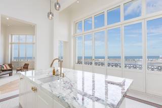UNIQUE THREE-BEDROOM FLAT IN LISTED CORNER VILLA ON OSTEND SEAFRONT<br />In <strong>villa Louiza</strong>, we are pleased to offer you the belle-floor flat. With an exceptional façade width of 14m, this flat has a fantastic view of the sea and the Ostend seafront. The flat consists of a dining area, winter terrace, fully fitted luxury kitchen, exceptional living room with gas fireplace, two bedrooms each with its own bathroom overlooking the inner garden of the Troon 17 project, separate WC, third room accessible via the hallway, with its own shower room and separate WC.<br />This flat is finished to a very high standard with frieze parquet, beautiful natural stone, underfloor heating, all with attention to detail. The high ceilings with original moulures give a very spacious and light feeling.  The flat also has a spacious basement. There is possibility to buy a garage box.
<ul>
	<li>Indoor area : 180 m², Garden/terrace area : 35 m², Cellar : 15.4 m²</li>
	<li>Luxurious finishing with all modern comfort in one of the most characteristic buildings on the Zeedijk</li>
	<li>Bicycle shed</li>
	<li>Possibility to buy a garage</li>
	<li>Sale under registration duties</li>
	<li>EPC: 89 / A</li>
</ul>