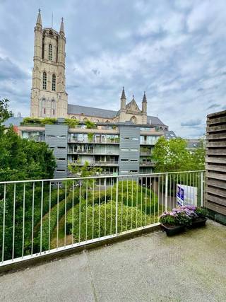 TE HUUR - GENT. In het historische hart van Gent, vlak bij de Sint-Baafskathedraal: stijlvol dakappartement op de derde verdieping met een prachtig uitzicht en een uitzonderlijk rustige ligging. De lichtrijke leefruimte met open keuken sluit naadloos aan op een ruim terras – perfect om te genieten van de zon en het uitzicht. Verder zijn er twee volwaardige slaapkamers, een moderne badkamer, een apart toilet en een praktische berging. Extra troeven: mogelijkheid tot gebruik van een gemeenschappelijk dakterras én tot het bijhuren van een staanplaats in het gebouw. Energiezuinig (EPC 157 kWh/m² – UC: 1201595). Huurprijs: €1.275/maand + €185/maand voorschot op verwarming en algemene kosten. Een unieke kans voor wie comfort zoekt in het hart van de stad.