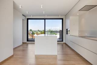 This exclusive building is a true haven of peace, strategically located near the vibrant heart of Aalter. You will be welcomed into an elegant entrance hall with a seamlessly integrated cloakroom. From here, you enter the lush, open living space. This room exudes pure class thanks to the atmospheric gas fireplace and floor-to-ceiling windows that open the space beautifully to the spacious terrace. The hyper-installed custom kitchen is a masterpiece in itself and an absolute dream for every culinary gourmet.The sophisticated night hall leads to a stylish guest toilet and two majestic bedrooms, one of which is fully equipped with floor-to-ceiling wardrobes. Both luxurious bedrooms have their own en-suite bathroom with a spacious walk-in shower. A laundry room and an extremely practical storage room complete the well thought-out layout.This home gem is 100% ready to move in: the interior is fully painted and meticulously provided with mood lighting. You can enjoy a flawless living environment all year round thanks to integrated air conditioning, automatic sunscreens, a ventilation system and private solar panels. An underground cellar and a secure, closed garage box are included as standard and maximize your daily comfort.Trade union information on request.Register of measures: no