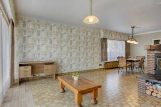 Deze woning is centraal gelegen in Dessel, vlakbij het kanaal Bocholt-Herentals op fietsafstand van het centrum en lokale winkels. Er is een vlotte verbinding naar omliggende gehuchten en gemeenten, alsook naar de E34 Antwerpen–Eindhoven.<br /><br />Via de inkomhal, met vestiaireruimte, kom je in de L-vormige woonkamer, die is opgedeeld in een zit- en eethoek. Dankzij de grote ramen geniet je hier van aangename lichtinval, terwijl de inbouwhaard zorgt voor extra gezelligheid in de koude wintermaanden. De keuken werd in 2018 vernieuwd en is voorzien van een koelkast, combi-oven, stoomoven, inductiekookplaat, afzuigkap, vaatwasser, dubbele spoeltafel, granieten werkbladen, voldoende kastruimte en een ontbijthoek. De veranda, voorzien van inbouwkasten, fungeert een groot deel van het jaar als extra leefruimte. Verder is er een apart toilet en een wasplaats/berging.<br /><br />Het slaapgedeelte bevindt zich vier treden hoger. De nachthal geeft toegang tot drie slaapkamers, waarvan twee voorzien zijn van inbouwkasten, en een volledig betegelde badkamer (2018) met ruime douche, wastafel in meubel, extra toilet en een inbouwkast.<br /><br />De woning beschikt over een ruime droge kelder; het overige deel is kruipkelder. Via een luik met uitschuiftrap bereik je de ruime zolder, die nog extra mogelijkheden biedt qua inrichting. Het dak en de bijhorende isolatie werden in 2020 volledig vernieuwd. In 2021 werden bovendien 12 zonnepanelen geïnstalleerd. De ramen dateren van 1992.<br /><br />In de tuin is er een ruime gemetselde garage met extra opbergruimte, een houten tuinhuis en een bijkomende bergruimte, bijvoorbeeld voor het stockeren van hout.<br /><br />Deze woning werd degelijk gebouwd en is altijd goed onderhouden. Ben je op zoek naar een ruim ingedeelde woning met veel opbergruimte? Dan is deze woning zeker het bekijken waard.<br /><br />— stedenbouwkundige inlichtingen in aanvraag —