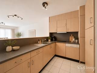Dit ruime en lichtrijke gelijkvloers appartement combineert een praktische indeling met heel wat extra mogelijkheden.<br />Via de inkomhal kom je binnen in de ruime leefruimte met grote raampartijen die voor veel natuurlijk licht zorgen. Aansluitend bevindt zich de praktische keuken, voorzien van voldoende kastruimte en werkoppervlak. Het appartement beschikt over twee slaapkamers. De hoofdslaapkamer biedt voldoende ruimte voor een tweepersoonsbed, terwijl de tweede slaapkamer perfect kan worden ingericht als kinder- of logeerkamer. Er is ook nog een afzonderlijke extra ruimte, ideaal als bureau, dressing of praktische opslagruimte.<br />De badkamer is uitgerust met een dubbele wastafel en een ligbad met douchevoorziening.<br />Aan de voorzijde beschikt het appartement over een voortuin. Ook achteraan is er bijkomende buitenruimte, waar je de mogelijkheid hebt om een gezellig terras te creëren of een wagen te parkeren. Bovendien behoort er een privatieve garagebox tot het appartement, ideaal voor het veilig stallen van de wagen en/of als extra bergruimte.<br />Een veelzijdig gelijkvloers appartement met twee slaapkamers, een multifunctionele extra ruimte, buitenruimte voor- én achteraan en een garagebox.