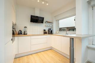 <p><span> </span></p><p><span>Wonen in de rustige Groenenhoek, vlakbij Berchem station?  In dit gerenoveerde appartement op de tweede verdieping van een kleinschalig gebouw vind je licht, ruimte en comfort. De moderne keuken, de luchtige leefruimte en het terras met open zicht maken dit een bijzonder fijne plek om thuis te komen. Energiezuinig (EPC B) én met airco in de master bedroom!</span></p><p><span> </span></p><p><span>Slim ingedeeld en stijlvol gerenoveerd</span></p><p><span>Je komt binnen via de hal, waar meteen de industriële glazen deur met zwart frame opvalt. Achter die deur ligt de grote leefruimte van maar liefst 34 m² op lichte vloer, met een gezellige zithoek en ruime eettafel. De kamer baadt in het licht dankzij de brede raampartijen en is voorzien van elektrische rolluiken (bedienbaar met afstandsbediening) en een slimme thermostaat.  De witte, open keuken werd in 2019 volledig vernieuwd en heeft alles wat je nodig hebt: inductiekookplaat, combi-oven, ijskast, diepvries, stijlvolle dampkap en veel kastruimte. Alles in frisse, moderne stijl met een werkblad in houtlook en witte wandtegels. Ook hier is veel natuurlijk licht dankzij een raam naar de straatzijde.</span></p><p><span> </span></p><p><span>Comfortabel, rustig slapen en vernieuwde badkamer</span></p><p><span>De master bedroom van 14 m² heeft directe toegang tot het terras en is uitgerust met airco, parketlaminaat en elektrische rolluiken. De tweede slaapkamer (12,5 m²) is eveneens afgewerkt met parketlaminaat en biedt ruimte voor een logeer- of kinderkamer, of voor een comfortabel thuiskantoor.  De badkamer is volledig vernieuwd met moderne, grijze wand- en vloertegels, een zwarte regendouche, wit badkamermeubel met zwarte grepen, en een praktisch afzuigsysteem. In de aparte berging is er een aansluiting voor wasmachine en droogkast. Het apart toilet is netjes afgewerkt met witte en grijze tegels en een hangtoilet.</span></p><p><span> </span></p><p><span>Zalig wonen in de Groenenhoek</span></p><p><span>Dit appartement ligt in een rustige straat met weinig passage, in de geliefde wijk Groenenhoek. Je bent hier op wandel- of fietsafstand van het Te Boelaarpark, scholen, supermarkten en gezellige cafés. Het station van Berchem ligt op slechts 5 minuten fietsen, en via de nabijgelegen Ring en invalswegen ben je zo de stad uit.</span></p><p><span> </span></p><p><span> </span></p>