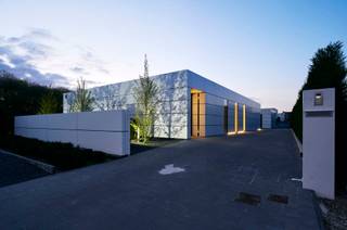<strong>EXCLUSIEVE DESIGNWONING MET TIJDLOZE ARCHITECTUUR EN HIGH-END AFWERKING.<br /></strong><br />In Dilsen-Stokkem bevindt zich deze uitzonderlijke designwoning, een architecturale parel waarin minimalisme, technologie en wooncomfort naadloos samenkomen. Deze unieke residentie werd ontworpen als visitekaartje van PAS Interieurconcepten en ademt visie, vakmanschap en pure woonbeleving.<br /><br />De woning onderscheidt zich onmiddellijk door haar strakke en tijdloze architectuur. Aluminium cassettes, grote profielloze glaspartijen en een doorgedreven lijnenspel creëren een bijzonder esthetisch geheel waarbij binnen- en buitenruimte perfect in elkaar overvloeien. Elk detail werd doordacht uitgewerkt met oog voor functionaliteit, rust en verfijning.<br /><br />Binnen geniet u van een exclusief interieurconcept waarin technieken volledig geïntegreerd werden in het ontwerp. Keukentoestellen, deuren en opbergruimtes verdwijnen subtiel in maatwerk, waardoor een uiterst sereen en luxueus totaalbeeld ontstaat. De woning beschikt bovendien over innovatieve technieken zoals vloerverwarming gecombineerd met plafondpanelen voor zowel verwarming als koeling, een centraal stofzuigsysteem, uitgebreid domotica-systeem en een uitzonderlijk energiezuinig karakter.<br /><br />De indeling van de woning werd ontworpen met focus op comfort, lichtinval en praktische leefbaarheid. Via de stijlvolle inkomhal bereikt u het gastentoilet, de ruime leefruimte en de luxueuze leefkeuken, die samen het hart van de woning vormen. De master bedroom beschikt over een ensuite badkamer en biedt een oase van rust en privacy. Verder bevindt zich op het gelijkvloers nog een tweede slaapkamer met eigen badkamer en daarnaast een praktische wasplaats.<br /><br />In de kelderverdieping bevinden zich nog twee volwaardige slaapkamers, een polyvalente hobbyruimte of kantoorruimte en een technische ruimte.<br /><br />Ook buiten werd niets aan het toeval overgelaten. De prachtige zwemvijver en ingebouwde jacuzzi zorgen voor een unieke vakantiesfeer in eigen tuin, terwijl de vrijstaande garage van ca. 100m² tal van mogelijkheden biedt voor wagenliefhebbers, opslag of hobbyactiviteiten.<br />Dankzij de hoogwaardige isolatieschil en het vooruitstrevende ontwerp behaalt deze woning een indrukwekkend energiepeil, volledig afgestemd op hedendaags en toekomstgericht wonen.<br /><br />Deze eigendom is meer dan een woning — het is een totaalconcept waarin architectuur, interieur en techniek elkaar versterken tot een unieke woonervaring. Een zeldzame opportuniteit voor liefhebbers van design, luxe en compromisloos comfort.<br /><br />Interesse in deze exclusieve architectenwoning? Contacteer ons voor meer informatie of een persoonlijke rondleiding.