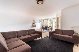 This spacious and bright apartment is located on the 2nd floor of Kruishofstraat, close to the A12 and Jan van Rijswijcklaan, ensuring easy access to Ghent, Brussels and the Netherlands. It enjoys a prime residential setting between Expowijk, Wilrijk and Park “Den Brandt”, with shops, supermarkets and restaurants within walking distance.

The large living room has big windows providing plenty of natural light and open views of the green square opposite. There is ample space for a lounge, dining area and even a home office. The adjoining kitchen was recently renovated and fitted with induction hob, dishwasher and convection oven.

At the rear, two spacious bedrooms both open onto a sunny terrace with afternoon and evening sun. Each bedroom benefits from its own bathroom: one with double sink and bath-shower, the other with separate shower.

The entrance hall offers a cloakroom, guest toilet and utility room with connections for washer and dryer. A private cellar is included.

An underground parking space must be purchased additionally for €35,000, excluding registration tax.