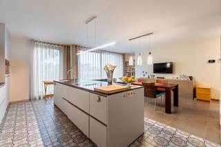 This luxury apartment is located on the top floor. It features a beautiful living space with an adjoining terrace, a fully equipped kitchen with storage room, 3 bedrooms, 2 bathrooms, and a private entrance hall. In the basement, there are 2 open parking spaces and a separate storage room.<br /><br />Luxurious finish!<br /><br />Layout:<br />The apartment is accessible via a staircase and an elevator that opens directly into the entrance hall exclusively for the apartment itself. You enter a spacious entrance hall with a guest toilet. From here, you have access to the bedrooms at the back and to the living area. The living space is very spacious and is divided into a sitting area and a dining area. You have access to the cozy terrace over the entire length of the living space. The terrace has a sunshade.<br /><br />The living space seamlessly transitions into the beautiful, fully equipped kitchen. The kitchen is equipped with high-quality appliances. Adjacent to the kitchen, there is a cool storage/laundry room.<br /><br />The hallway provides access to 3 beautiful bedrooms and 2 bathrooms. The master bedroom has an adjoining dressing room. The main bathroom is equipped with a walk-in shower, double sink, and toilet. The second bathroom has a walk-in shower, sink, and toilet.<br /><br />In the basement, there are 2 spacious parking spaces and a practical storage room.<br /><br />Special features:<br />- Wheelchair accessible<br />- Entrance hall completely private for the penthouse<br />- 2 parking spaces and very spacious storage<br />- 3 spacious bedrooms and 2 full bathrooms<br />- 3 toilets<br />- Located within walking distance of the center of Lommel