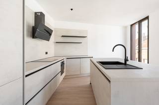 <h2>Authentiek industrieel wonen in Antwerpen</h2>
<p>Gelegen In de voormalige Whitbread-fabriek bevindt zich dit smaakvol ingericht twee slaapkamer appartement met ruim terras. De volledige site werd grondig gerenoveerd, met respect voor de oorspronkelijke architectuur en behoud van de authentieke uitstraling van het gebouw.</p>
<p>Het project combineert de charme van een historisch industrieel pand met het comfort en de kwaliteit van hedendaags wonen en werken. De <br />bestaande architecturale elementen werden zoveel mogelijk behouden en zorgvuldig geïntegreerd in een vernieuwde, eigentijdse omgeving.<br /><br />Dit stijlvolle appartement van ca. 108 m² ligt op de tweede verdieping van het voorgebouw aan de Maatstraat in Antwerpen. Het is ontworpen door Sculp[IT] architecten en combineert een open, ruime leefzone met twee slaapkamers, een eigen terras en een moderne, industriële uitstraling dankzij de zichtbeton en de grote raampartijen.<br /><br />Indeling: <br />Open leefruimte: Het hart van het appartement omvat een grote, open leefruimte van bijna 13,5 meter lang. Ze loopt vloeiend over van de leefruimte (zithoek) naar de keuken, met aan de gevel een doorlopende rij ramen die voor veel natuurlijk licht zorgt. Voor wie thuiswerkt werd een aparte werkhoek voorzien. <br /><br />Een ruime volledig ingerichte open keuken met een lang kookeiland.<br />Vanuit de leefruimte heeft u toegang tot het privéterras van circa 9 m², perfect voor een ontbijt of een glas wijn in de zon.<br /><br />Ruime hoofdslaapkamer van ca 12m2. Tweede slaapkamer, geschikt als kinderkamer, gastenkamer of tweede werkruimte.<br />Aparte badkamer voorzien van een inloopdouche, dubbele wastafel en toilet. <br />Separate bergplaats met aansluiting voor wasmachine en droogkast. <br /><br />Troeven<br />- Open, flexibele leefruimte met veel lichtinval<br />- Twee slaapkamers, gescheiden van de leefruimte voor rust en privacy<br />- Eigen terras en aparte bureauhoek<br />- Aparte WC en badkamer<br />- Hoogwaardige afwerking met zichtbeton en geïsoleerde buitenwanden<br />- Centrale ligging in Antwerpen</p>