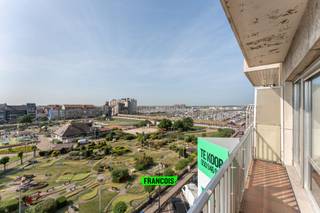 Op de Franchommelaan, een felbegeerde locatie in Blankenberge, treffen we dit ruim en uiterst lichtrijk appartement aan. Het appartement is gelegen op de 5de verdieping, wat resulteert in een prachtig verzicht. Horeca, winkels en openbaar vervoer zijn gelegen op wandelafstand. <br /><br />Dit ruim twee slaapkamer appartement is op de 5de verdieping gelegen van de residentie San Marco. Men komt binnen via de ruime inkomhal van het appartement die op zijn beurt rechtstreeks toegang geeft tot de opvallend aangename woonkamer met een balkon en een prachtig uitzicht op de mini-golf, jachthaven en hinterland. Aansluitend aan de woonkamer treft met de keukenruimte met berging. <br /><br />Verder is er een een apart toilet en een badkamer voorzien van enkele wastafel met ligbad en douchefunctie. <br /><br />Aan de achterzijde van het appartement bevinden zich 2 aangename slaapkamers (één grote en één iets kleinere). De kleinste kamer heeft toegang tot het terras achteraan die voorzien is van een handige berging. <br /><br />Het appartement wordt verwarmd door middel van centrale verwarming op aardgas en beschikt over dubbele beglazing. <br /><br />Hoewel dit appartement momenteel een renovatie of opfrissing vereist, biedt het een unieke kans om een droomwoning te creëren op een van de meest begeerde locaties van Blankenberge. Grijp deze kans om uw eigen stempel te drukken op dit pareltje aan de Belgische kust.<br /><br />Indien u een voorkeur geeft aan een andere verdieping, aarzel dan zeker niet om meer informatie te vragen. We kunnen in dit gebouw elke verdieping aanbieden in aankoop.<br /><br />Voor meer informatie of bezoek, neem gerust contact met ons op. Wij staan klaar om u te begeleiden bij deze unieke vastgoedervaring.<br /><br />Aarzel niet en leg nu uw afspraak vast!<br /><br />