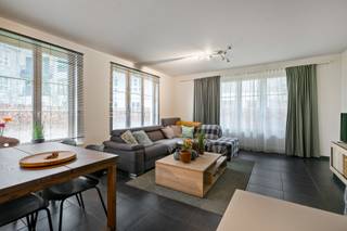 Rustig gelegen gelijkvloers appartement met twee slaapkamers en tuin. <br /><br />Indeling en omschrijving:<br />Via de inkomhal betreedt u het appartement. Aan de rechterzijde bevindt zich de praktische berging met aansluitingen voor wasmachine en droogkast. Links vindt u de eerste slaapkamer met aansluitende badkamer. De volledig betegelde badkamer is voorzien van een dubbele lavabo met meubel, douche en toilet. Verder in de hal bevindt zich de tweede slaapkamer en een apart gastentoilet. Aan de voorzijde van het appartement geniet u van de lichtrijke leefruimte. Vanuit de woonkamer heeft u toegang tot het zuidgeoriënteerde terras met tuin. De keuken is uitgerust met spoelbak, kookplaat, dampkap, kasten en koelkast. Tot slot beschikt het appartement over een praktische kelderbeging in het ondergrondse complex. <br /><br /><span>Extra info: autoplaats optioneel bij aan te kopen voor € 21.900 I EPC 224 kWh/ (m² jaar) label C I infoplicht: Vg, Wg, Gvv, Gvkr, Gmo I watertoets: P-score: A I G-score: A.</span>