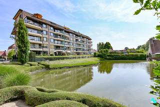 Dit energiezuinig, goed onderhouden en instapklaar appartement met twee slaapkamers is gelegen op de vierde verdieping van residentie 'Prinsessehof' in hartje Emelgem. Het appartement beschikt over een bewoonbare oppervlakte van ca. 108 m² (volgens EPC-attest) en is gelegen nabij het station, het openbaar vervoer, diverse handelszaken en het kanaal Roeselare-Leie. Indeling: riante inkomhal met gastentoilet, lichtrijke leefruimte met prachtig uitzicht, aansluitend een geïnstalleerde keuken (keramische kookplaat, dampkap, oven, koelkast en spoelbak) en technische berging/wasplaats. Verder geniet het appartement van twee ruime slaapkamers en een badkamer (voorzien van ligbad en dubbele wastafel). Verder heeft u vanuit de leefruimte toegang tot het zuidoost georiënteerd zonneterras, dat een mooi en rustgevend uitzicht biedt op het groen en de vijver. Tot slot is er de mogelijkheid tot het aankopen van een garagebox à 25.000 EUR. CV op aardgas (condenserende ketel anno 2024) | Rolluiken in de kamers | HR-beglazing | Voorzien van gordijnen | Energiezuinig appartement, EPC-label A | Asbestveilig | EK niet conform | Lift aanwezig | Gratis autostaanplaatsen voor de bewoners aan de voorkant van het appartementsgebouw . Contacteer ons voor meer informatie.