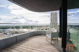 <strong>Move straight into the prestigious Ensor Tower</strong><br />Located on the <strong>10th floor of Ensor Tower in Oosteroever</strong>, Ostend, this stylish <strong>80 m²</strong> apartment, built in <strong>2021</strong>, is ready to move into.<br />Featuring two pleasant terraces, outstanding energy efficiency, and high-quality finishes, it offers modern coastal living in one of Ostend's most desirable locations.<br /><br /><strong>Bright living area with a sunny terrace</strong><br />The welcoming entrance hall with a practical cloakroom leads into a bright and inviting living room with <strong>unique sea views</strong>. Large floor-to-ceiling windows flood the space with natural light while showcasing breathtaking views.<br />The adjoining <strong>10 m²</strong> terrace enjoys the <strong>morning sun until around 2 p.m</strong>., making it the perfect spot for breakfast or a relaxing coffee in the sunshine.<br /><br /><strong>Modern open-plan kitchen</strong><br />The elegant open-plan kitchen blends seamlessly with the living area, creating a spacious and contemporary atmosphere. Its practical layout makes cooking and entertaining especially enjoyable.<br /><br /><strong>Two bedrooms with access to a second terrace</strong><br />The apartment features <strong>2 full-sized bedrooms</strong>, both fitted with <strong>built-in wardrobes</strong> and offering direct access to the generous <strong>8 m²</strong> second terrace.<br />This provides additional outdoor living space and beautiful views from both bedrooms.<br /><br /><strong>High-quality finishes and exceptional comfort</strong><br />Warm <strong>parquet flooring</strong> runs throughout the apartment and complements the comfortable <strong>underfloor heating</strong>, which is connected to the sustainable <strong>district heating network</strong>.<br />The bathroom features a walk-in shower and double washbasin, while a separate storage room and separate toilet add everyday convenience.<br /><br />With an excellent <strong>EPC rating of E43</strong> and an energy consumption of only <strong>66 kWh/m² per year</strong>, this home is exceptionally energy-efficient.<br /><br /><strong>Key features</strong><br /><span><strong>Prime location in Oosteroever</strong>, Ostend</span><br /><span><strong>Ensor Tower</strong> residence (built in <strong>2021</strong>)</span><br /><span>80 m² of living space + 2 terraces measuring 10 m² and 8 m²</span><br /><span>Underfloor heating connected to the district heating network</span><br /><span><strong>EPC E43 – 66 kWh/m²/year</strong></span><br /><span>Cadastral income: € 991</span><br /><span>Option to purchase an underground <strong>garage box</strong> (No. 56) nearby</span><br /><br /><br />Looking for an apartment for sale in Oosteroever, Ostend that combines modern comfort, outstanding energy efficiency, and a prime seaside location?<br />This apartment in Ensor Tower is a unique opportunity.