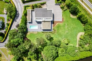 <br />Moderne luxe-villa met heel mooie tuin bestaande uit een inkomhal, living, ingerichte ruime keuken, bijkeuken, 2 slaapkamers, 2 badkamers, dressing, strijkkamer, wasplaats, dubbele garage en berging.<br />Op verdiep een appartement met aparte ingang en een living met open keuken, 3 slaapkamers, 3 badkamers, dressing en een terras.<br />Overdekt terras, zwembad en poolhouse op 5.664m². Ideaal voor kangoeroewonen. Ca. 600m² vloeroppervlakte. <br />