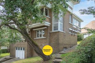 Deze woning is een beschermde, historische kustvilla gelegen in de prestigieuze villawijk De Concessie, een uniek en beschermd dorpsgezicht dat bekendstaat om zijn uitzonderlijke erfgoedwaarde en karaktervolle architectuur.<br /><br />Deze charmante villa uit 1933 bevindt zich op een toplocatie, op wandelafstand van het strand en het centrum van De Haan. Gelegen op een perceel van ca. 780 m² combineert deze eigendom authentieke charme, ruime volumes en een uitzonderlijk potentieel.<br /><br />Bij het binnenkomen wordt u verwelkomd in een statige inkomhal met authentieke tegelvloer en karaktervolle houten trap. De gezellige leefruimte ademt sfeer dankzij de originele vloeren, schouw en grote raampartijen die zorgen voor een aangename lichtinval. Aansluitend bevindt zich de keuken met toegang tot de tuin en de kelderverdieping. <br /><br />De eerste verdieping telt vier slaapkamers, waarvan meerdere voorzien zijn van een lavabo en ingemaakte kasten. De badkamer beschikt over een ligbad, lavabo en toilet. Via de tussenverdieping bereikt u een afgesloten veranda/dakterras met zicht op het groen.<br /><br />De ruime kelderverdieping omvat een garage, technische ruimte, berging, sanitaire ruimte met douche en diverse opslagmogelijkheden.<br /><br />Buiten geniet u van een prachtige, groene tuin met meerdere terrasplaatsen, volwassen bomen en een optimale privacy. <br /><br />Centrale verwarming op aardgas aanwezig. EPC: 590 kWh/m² jaar (label F). <br /><br />Een zeldzame opportuniteit om eigenaar te worden van een karaktervolle historische villa in één van de meest gegeerde en beschermde wijken van de Belgische kust.