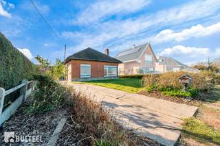Op zoek naar een landelijk gelegen bungalow op een toplocatie? Zoek niet verder. Mits de nodige renovatie tover je hier je droomwoning met weids uitzicht op de velden. De woning is gelegen in een rustige doodlopende straat, op een mooi perceel van 420m2 en geniet zowel voor- als achteraan van een open zicht op de velden. Via de inkomhal komen we in de ruime woonkamer met aansluitend de keuken en wasplaats/berging. Verder zijn er twee slaapkamers, een badkamer met lavabomeubel, douche, en toilet. Mits verdere afwerking kunnen extra kamers gemaakt worden op zolder. In de tuin vinden we een garage en tuinhuis. Hier woon je heerlijk rustig, weg van de drukte, maar toch met alles binnen handbereik. Laat deze kans niet voorbijgaan en plan vandaag nog je bezoek in!