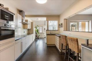 Exclusieve, hyper-geïnstalleerde woning (3 slpk.) met zwemvijver op een riant perceel van ca. 1.602 m², gelegen in een residentiële en groene omgeving.<br /><br />Deze energiezuinige woning met hoogwaardige afwerking heeft recente technieken zoals zonnepanelen (7,4 kVa), ventilatie C+ met extra's, een warmtepomp in combinatie met cv op gas, thuisbatterij en laadpaal (2025) evenals conforme elektriciteit (2026), behaalt de woning een uitstekende EPC-score van 114 kWh/m² . Alles met app-sturing.<br /><br />Ligging:<br />Rustig en residentieel met veel groen.<br /><br />Omschrijving:<br />De inkomhal met gastentoilet leidt naar de woonkamer en daarnaast de zitruimte met gezellige gashaard, met maatwerk en raambekleding gaat u naadloos naar de open keuken en ontbijthoek/veranda. Deze creëren een optimale connectie met de tuin en zwemvijver. Op het gelijkvloers treft u ook de kantoorruimte, deze heeft een rechtstreekse toegangsdeur van buitenaf met toegangscontrole en parking.<br /><br />De volledig uitgeruste leefkeuken met aparte ontbijthoek beschikt over recente, hoogwaardige toestellen en sluit aan op een praktische berging met wasplaats en douche. Het gelijkvloers, inclusief de kantoorruimte en de badkamer nivo 1, is voorzien van vloerverwarming.<br /><br />Op de verdieping geeft de nachthal toegang tot drie grote slaapkamers en een design badkamer. De masterbedroom wordt gekenmerkt door een open vide en een hoog plafond, wat zorgt voor een ruimtelijk gevoel. Alle kamers hebben recente ingemaakte kasten in lakwerk of houtfineer. Verder is er een handige kelder, afgewerkte zolder en is er buiten een ruime dubbele garage met automatische poort, deze zorgen voor een aanwezige opbergruimte. Verder aanwezig domotica, automatisch hekwerk en beveiliging.<br /><br />De volledig aangelegde tuin vormt een absolute troef: de ruime tuin met ideale zuid-oriëntatie biedt maximale zoninval en privacy. De zwemvijver en het groene uitzicht zorgen voor een unieke beleving, midden in een rustige en natuurlijke omgeving. Meer info www.heylenvastgoed.be<br />